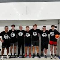 Students wearing championship shirts from a futsal tournament